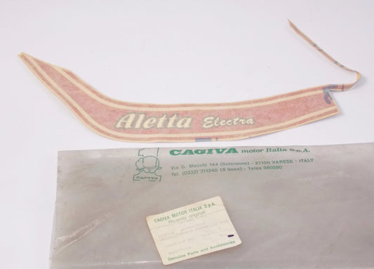 NOS OEM CAGIVA ALETTA ELECTRA 125 LH COVER STICKER "Aletta Electra" 800041903 - MotoRaider